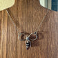 Sterling silver oxidized small bow necklace with black onyx and sterling flower spacers