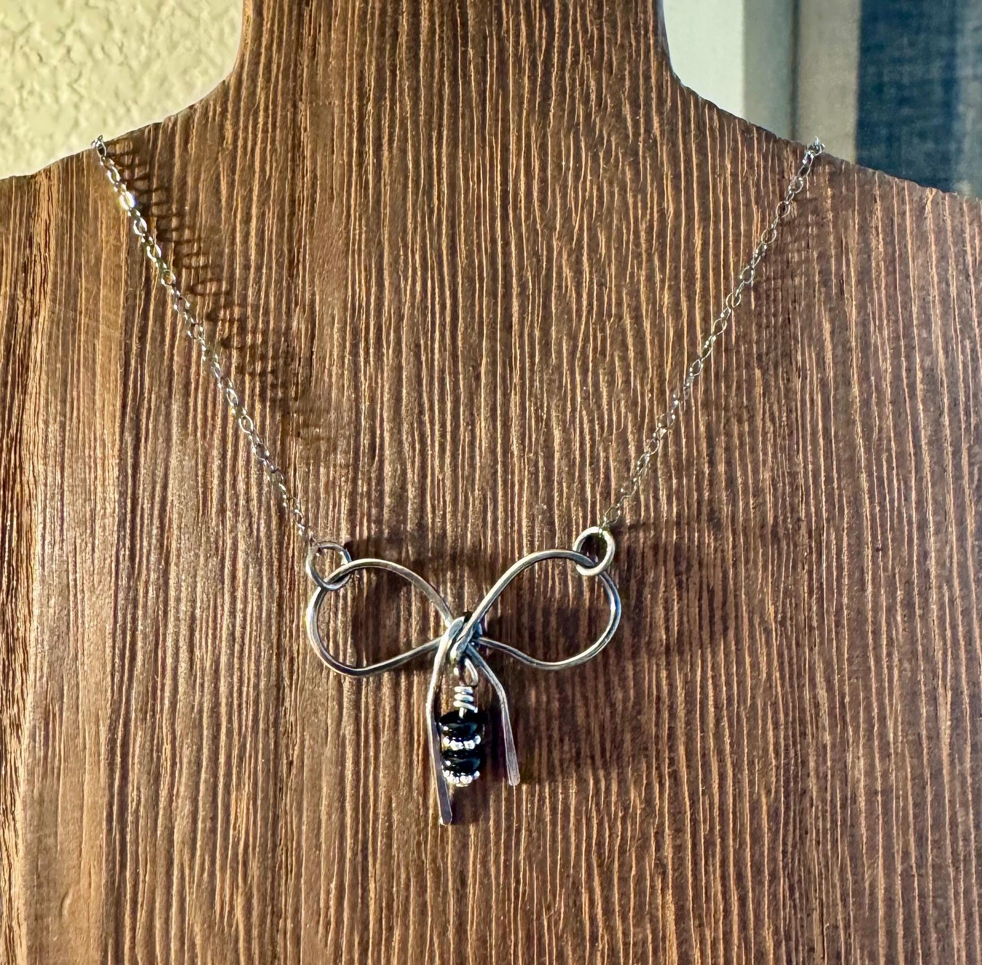 Sterling silver oxidized small bow necklace with black onyx and sterling flower spacers