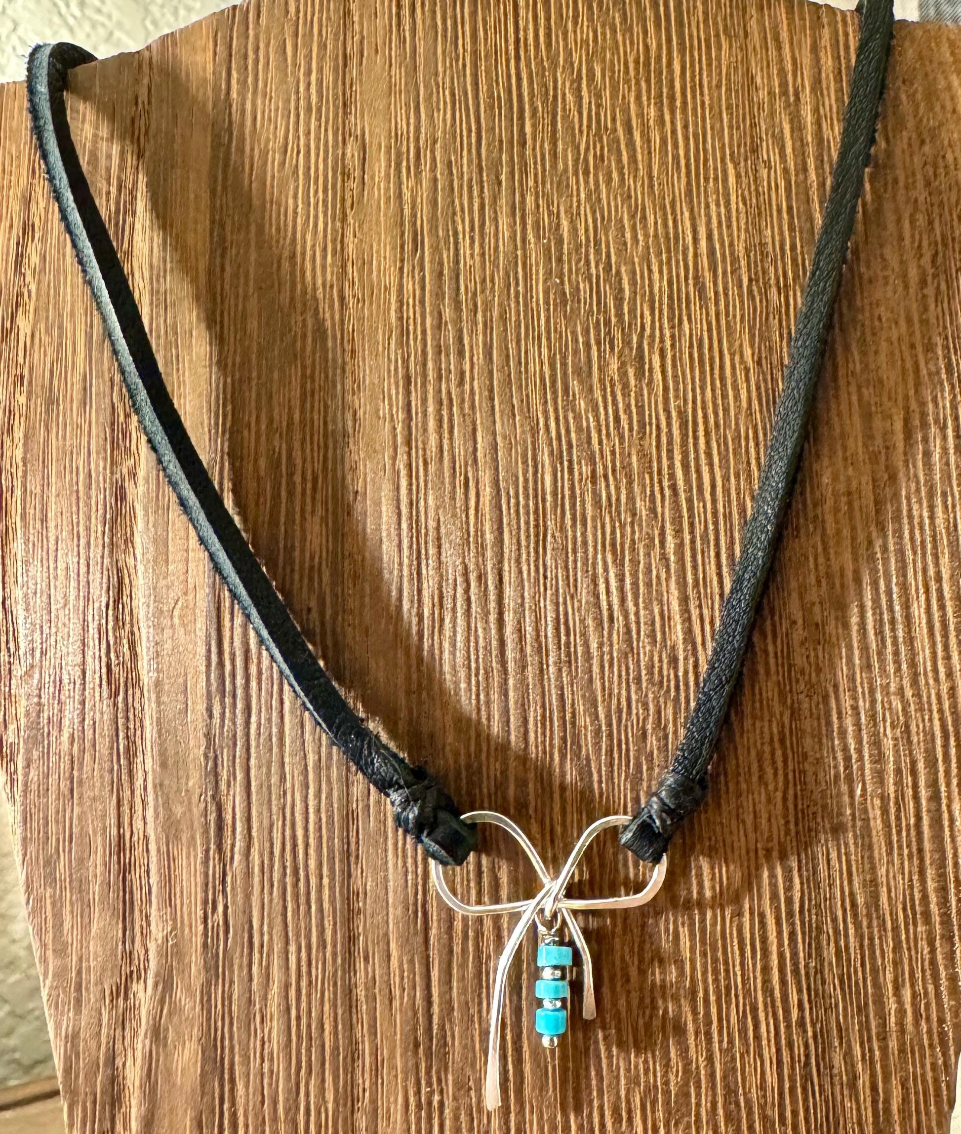 Dainty little silver handmade bow on genuine deerskin single leather lace with turquoise dangle