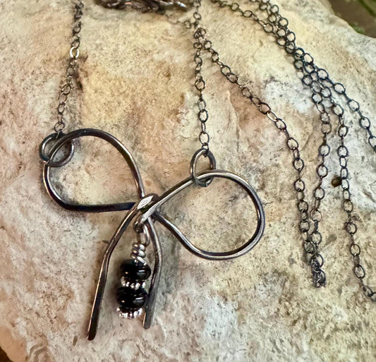 Sterling silver oxidized small bow necklace with black onyx and sterling flower spacers