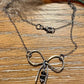 Sterling silver oxidized small bow necklace with black onyx and sterling flower spacers