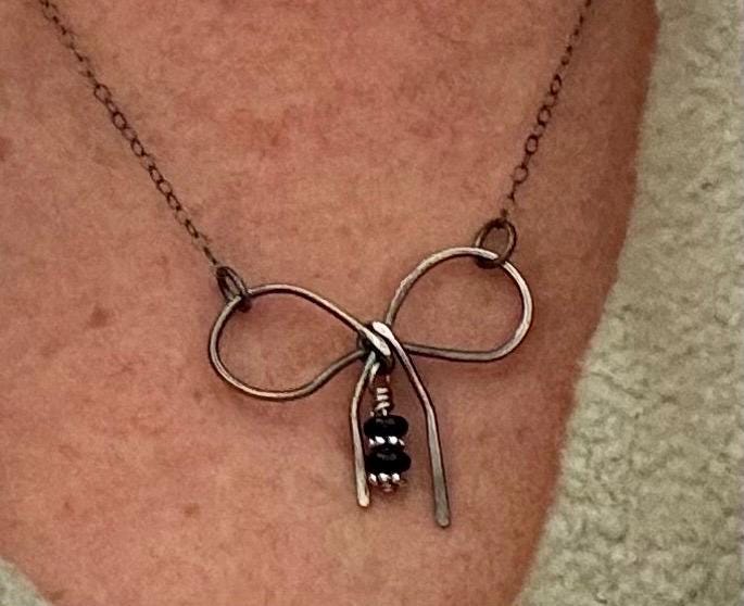 Sterling silver oxidized small bow necklace with black onyx and sterling flower spacers
