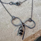 Sterling silver oxidized small bow necklace with black onyx and sterling flower spacers