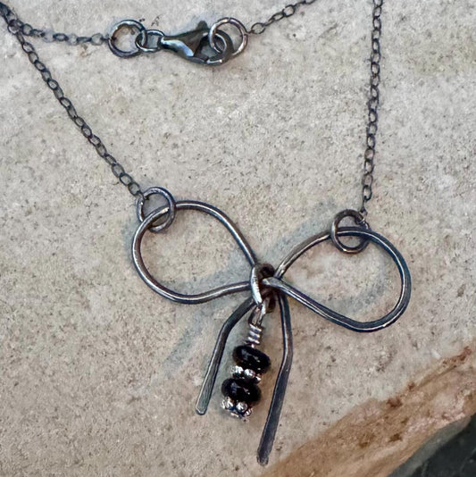 Sterling silver oxidized small bow necklace with black onyx and sterling flower spacers