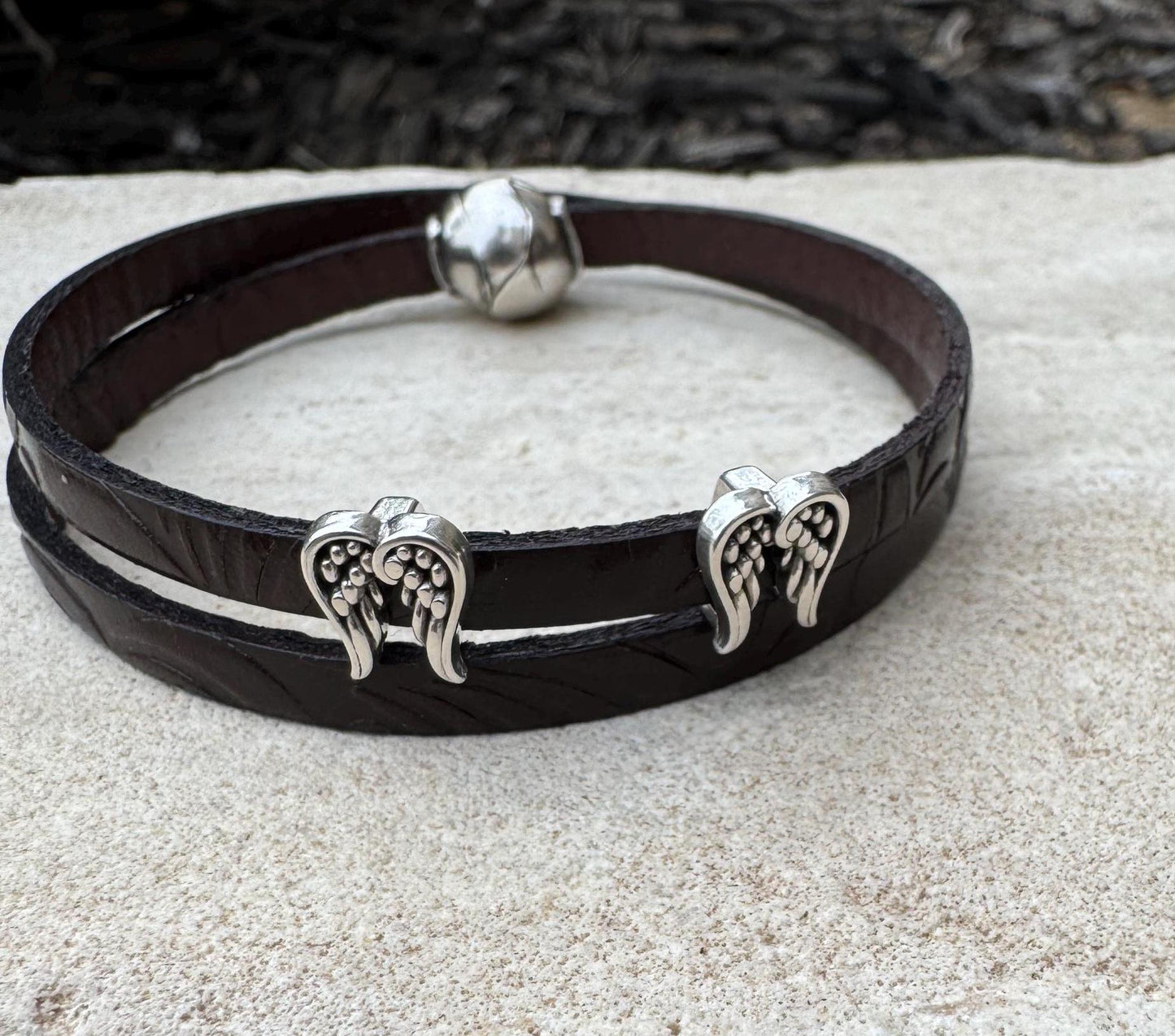 Embossed flower pattern leather wrap bracelet with angel wings spacers and magnet closure, black or dark brown leather