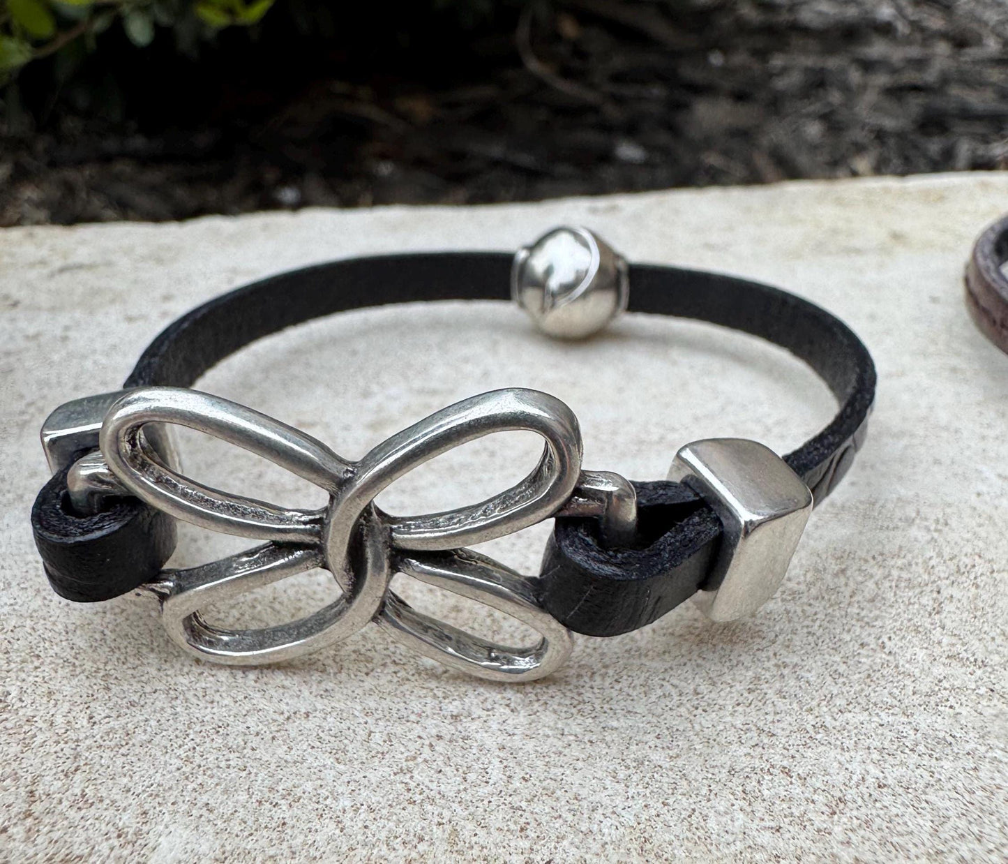 Embossed leather bracelet with stainless steel twisted butterfly connector, dark brown or black