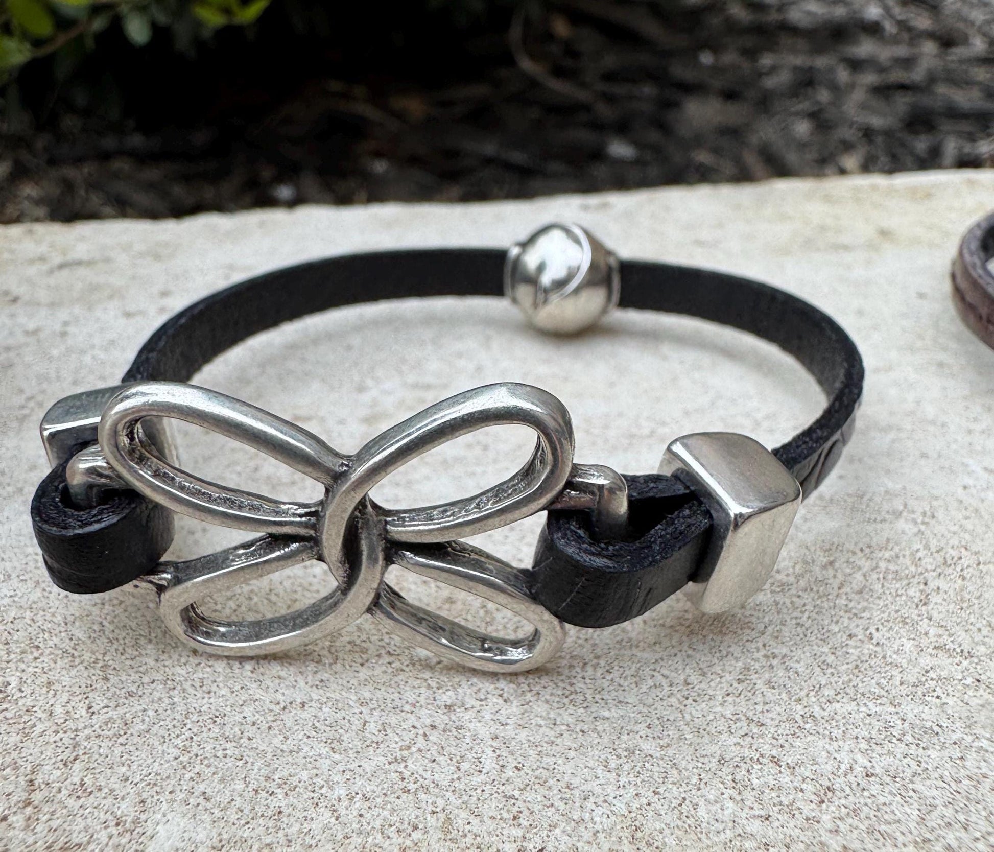 Embossed leather bracelet with stainless steel twisted butterfly connector, dark brown or black