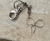Keychain with black pink rhodonite gemstones and sterling silver bow