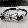 Embossed leather bracelet with stainless steel twisted butterfly connector, dark brown or black